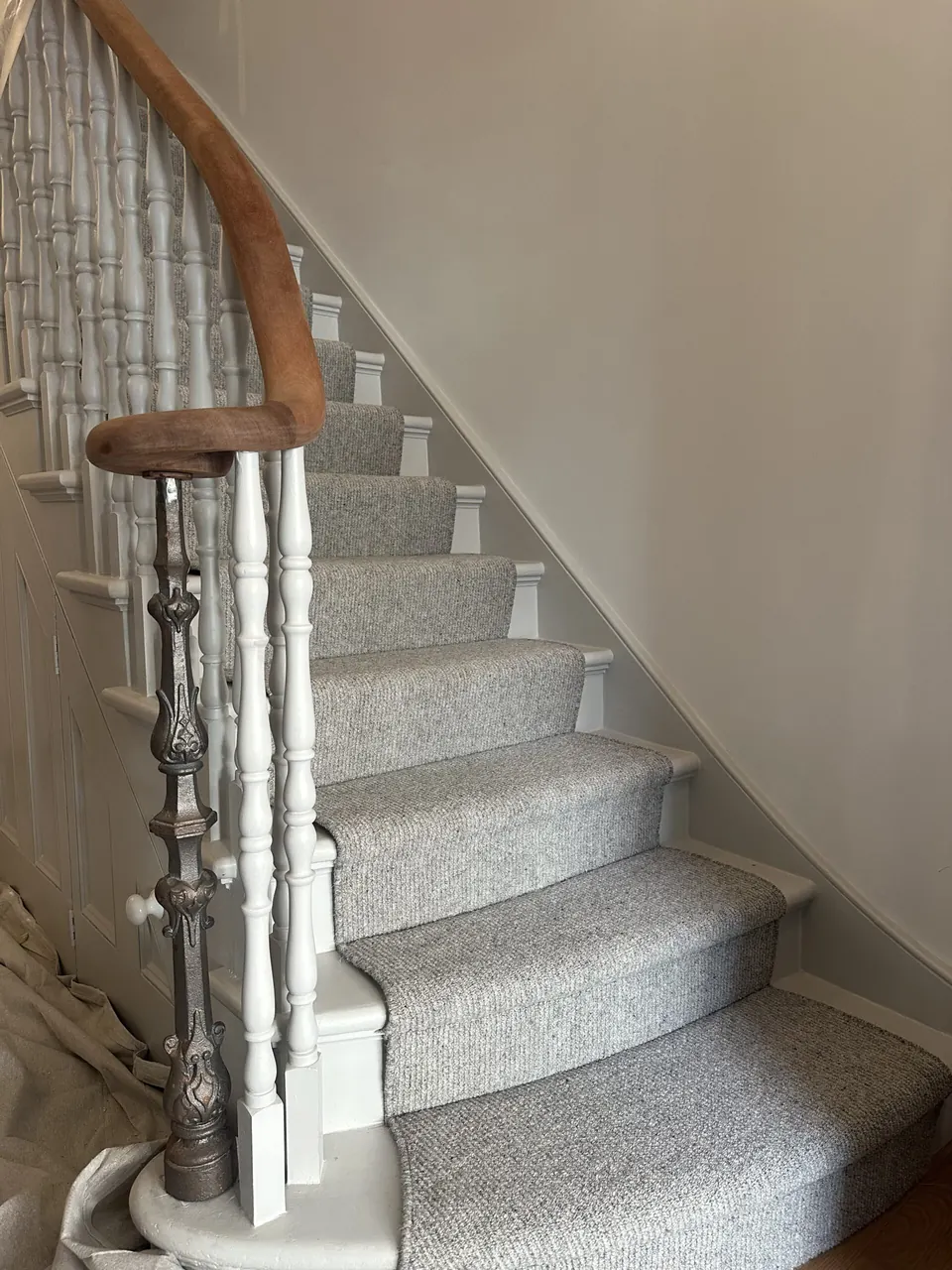 Restored newel post and turned spindles at the foot of the staircase