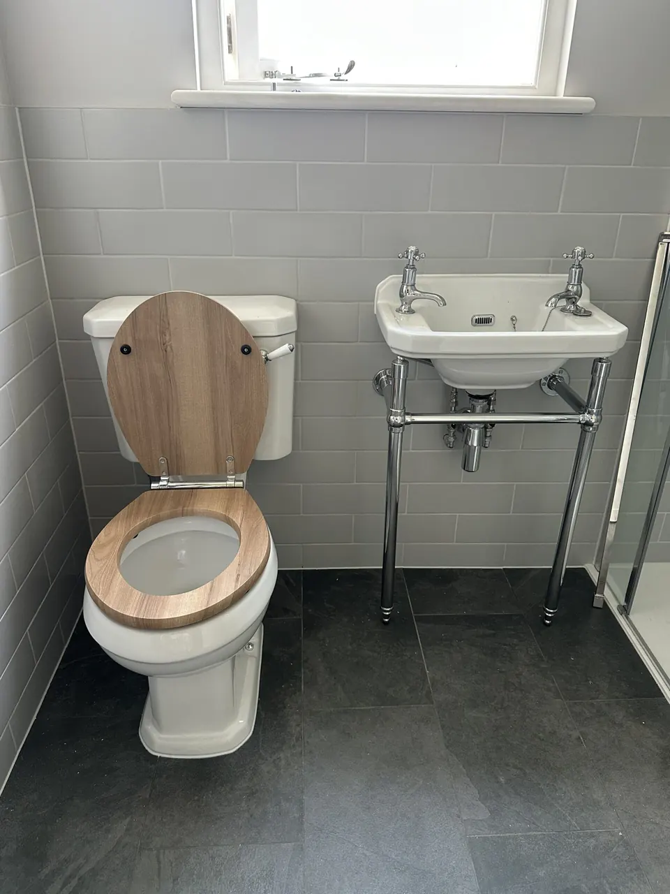 Shower room with traditional basin and toilet on slate-effect tiles