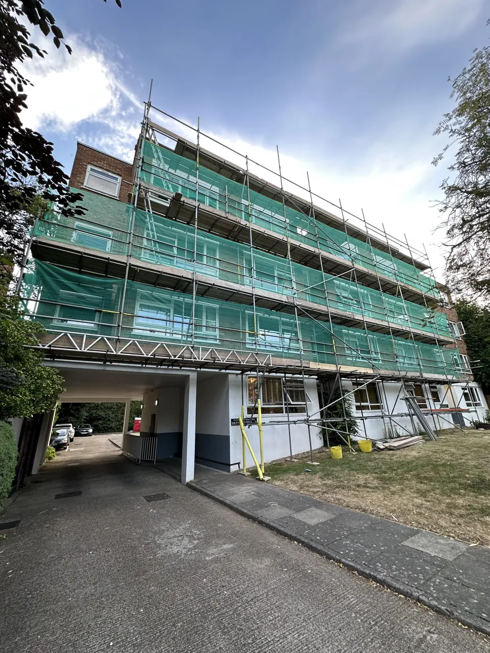 Scaffolded residential block above garages at Parkwood, Ealing