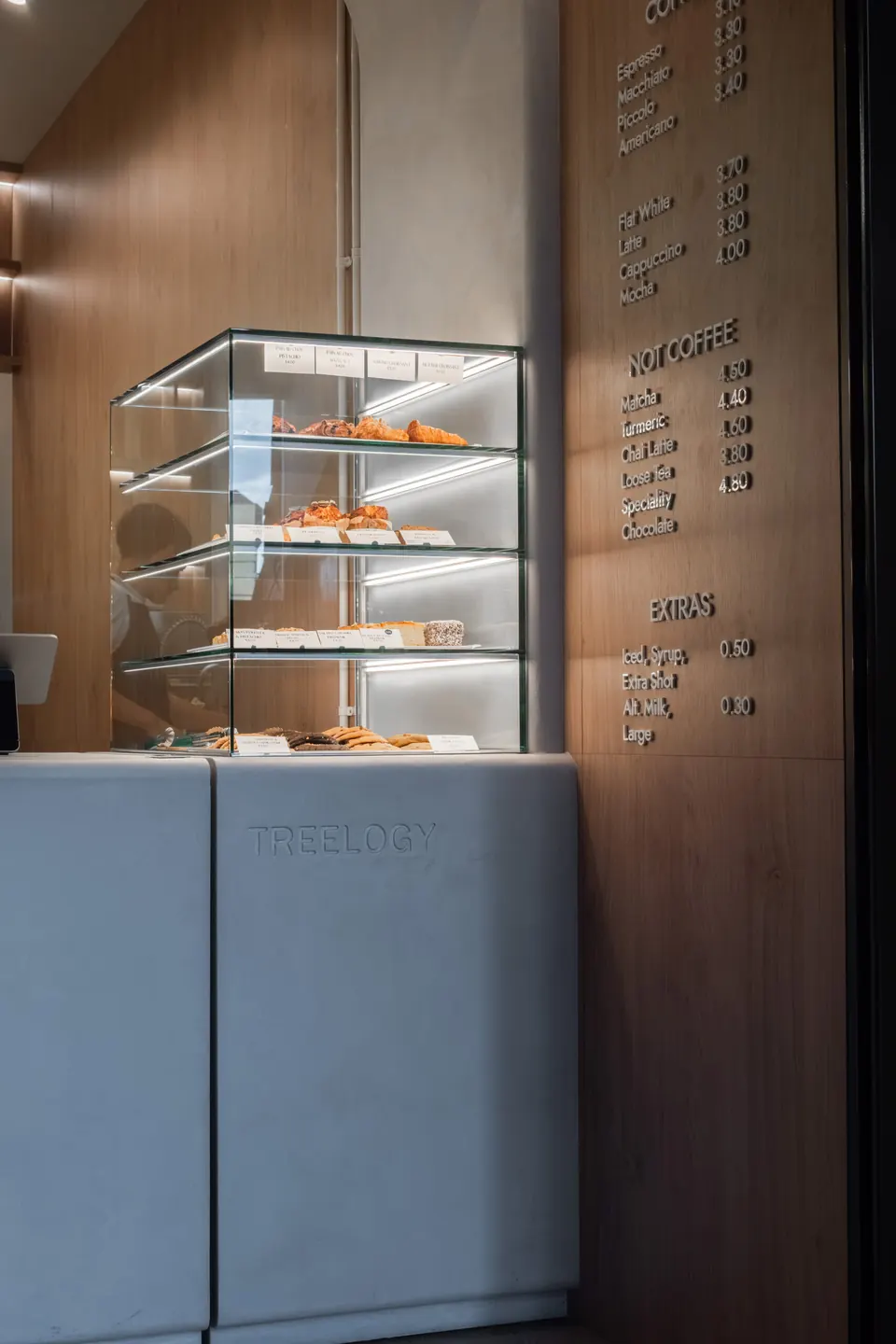 Pastry cabinet and timber wall panel at Treelogy